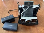 Polaroid Land Camera Model 195 W/F3.8 Tomioka Lens & Portrait Close-up Kits. Fixed Price $329.00.