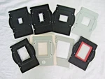 Set Of Eight Omega Type Negative Carriers, All Different, One With Glass. Fixed Price $240.00.